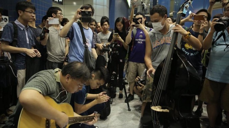 Music lovers play music at MTR station to vent out their anger over baggage rules.
