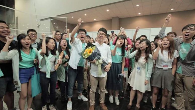A student group, Demosisto, celebrates the victory of their co-founder, Nathan Law, a former Occupy Central student leader, in the Legco election.