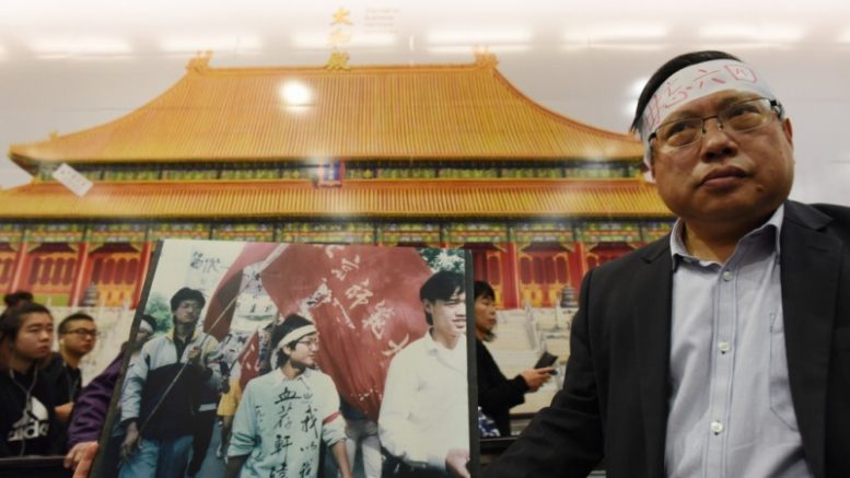 Make no mistake. This is not Tiananmen Square, nor 1989. Democrat Albert Ho, whose headband carried a slogan, 'not to forget June 4', protests at Central MTR station, where an exhibition of Beijing Palace Museum is underway.