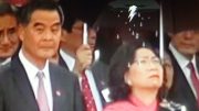Tong Ching-yee, wife of Leung Chun-ying is visibly upset in rain when Leung follows Liaison Office director to brave the rain at a National Day ceremony.
