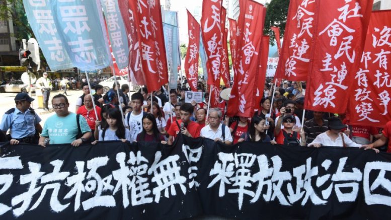 Angry Hongkongers stage a protest against the jailing of four student leaders.