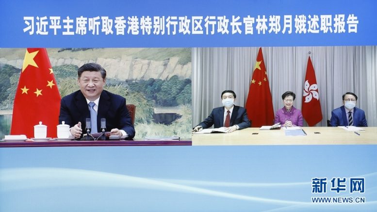 Liaison Office director Luo Huining sits next to Carrie Lam as she reports duty to President Xi Jinping via online.