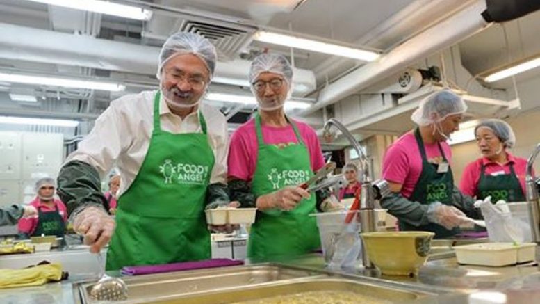 Financial Secretary John Tsang joins his predecessor Antony Leung at a charity project organised by Food Angel. Both are tipped as hopefuls for the next chief executive.